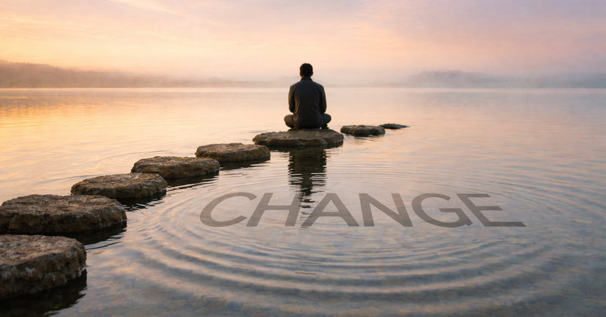 Man sitting on breakwater rocks reflecting on change
